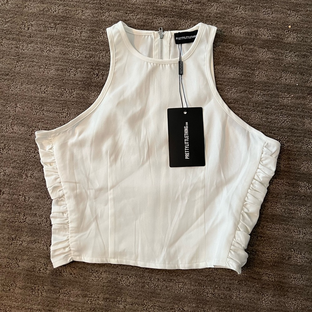 Two pieces white set. Razor back top. Straight pant with inner ankle slit.